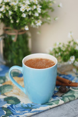 Blue Cup of Coffee Milk Latte Drink Cinnamon Sticks Wooden Background Rustic Camomile Flower Buquet Flat Lay