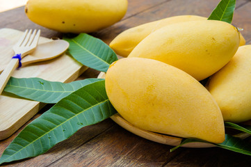 sweet yellow mango fruit on summer on wood table