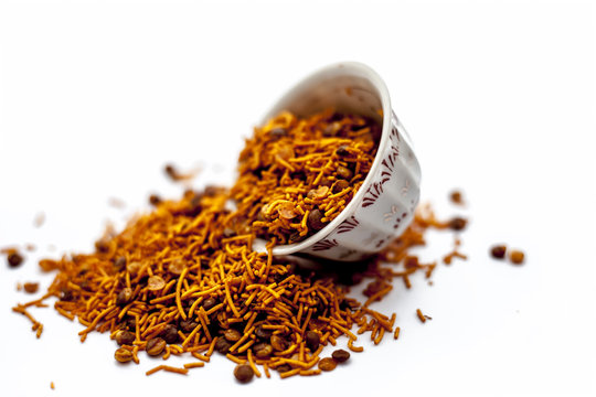 Popular Indian & Gujarati dish Dal muth or DAL MOOTH in a glass bowl isolated white eaten as a fast food snack, appetizer and  as a junk food also.