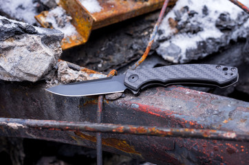 Knife with a black blade and handle.