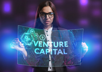 The concept of business, technology, the Internet and the network. A young entrepreneur working on a virtual screen of the future and sees the inscription: Venture capital