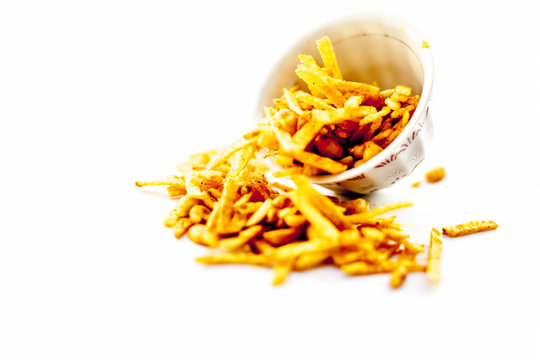 Popular Indian & Asian snack Farali chevdo or Faralu chivdo or potato fries with peanut in a glass bowl isolated on white.