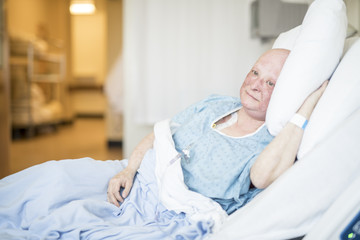 woman in hospital bed suffering from cancer