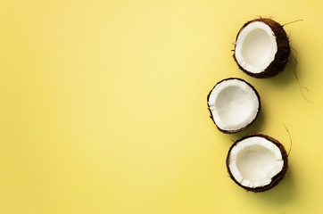Pattern with ripe coconuts on yellow background. Top View. Copy Space. Pop art design, creative...