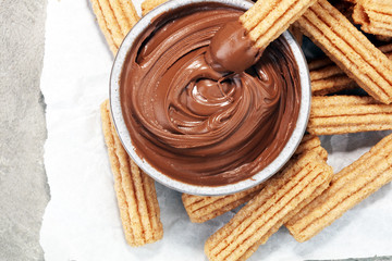 Traditional Spanish dessert churros with sugar and chocolate