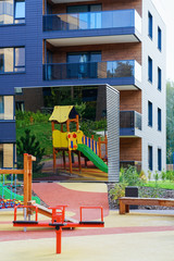 Fototapeta na wymiar Children playground at European modern residential building quarter