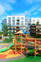Fototapeta na wymiar Children playground at complex of apartment building quarter