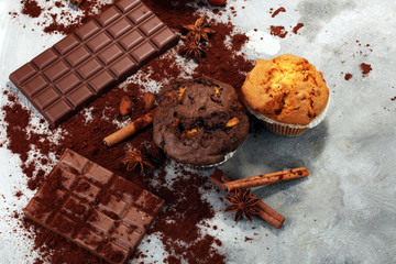 Chocolate muffin and nut muffin, homemade bakery on grey background