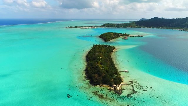 Aerial view of tropical paradise of Bora Bora island, crystal clear water of scenic turquoise blue lagoon - South Pacific Ocean, French Polynesia, 4k UHD