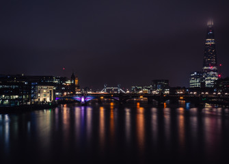 beautiful view of London at night, light reflections on river thames
