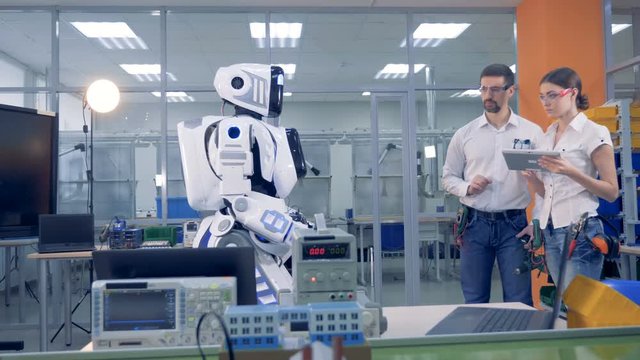 Human-like robot is coming to the engineers who control it remotely and give it a drill