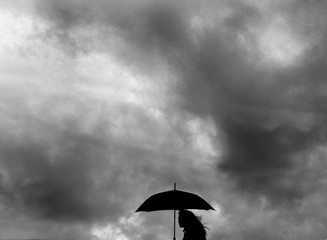 female silhouette with umbrella