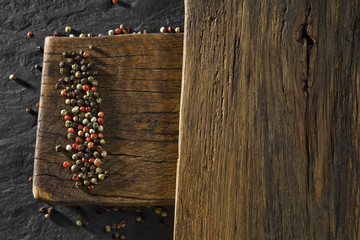 Top view of colour pepper on wooden desk and black table background