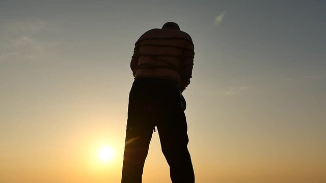 bondaged with rope man trying to liberate isolated silhouette slow motion