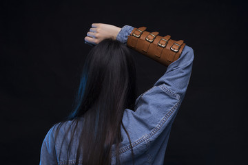 Young woman in blue denim jacket wearing fighter leather arm protection, confidence concept