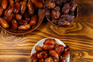 Dried dates fruit on wooden table. Top view