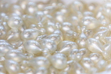 Background - close up of countless white and shiny medicine  pills with shallow depth of field, bokeh