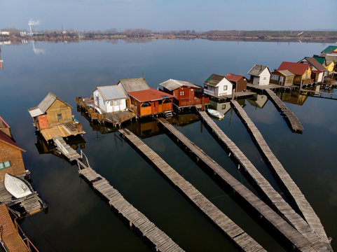 fishing and boat houses on a lake, drone aerial view in cinematic film look