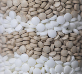 Background - close up of countless colourful medicine  tablets with shallow depth of field, bokeh