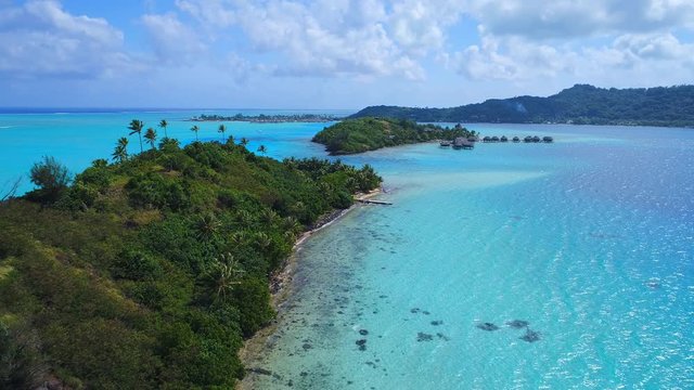Aerial view of tropical paradise of Bora Bora island, crystal clear water of scenic turquoise blue lagoon - South Pacific Ocean, French Polynesia, 4k UHD