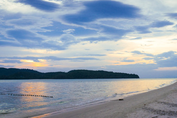 Sunset on the beach with dramatic sky, coast of island Langkawi, Malaysia