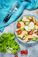 Fresh caesar salad in plate on concrete table. Top