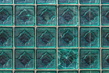 A beautiful horizontal texture of part of a glass transparent square brick wall in green hue