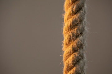 Isolated thick rope on a blurred background. Close-up photo.