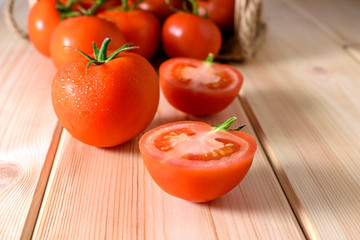 Close-up of fresh, ripe tomatoes on wooden background.