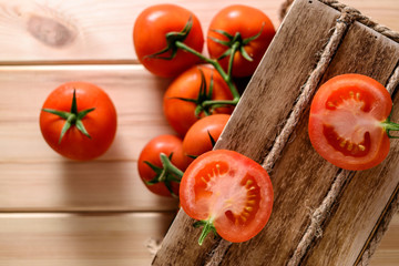 Close-up of fresh, ripe tomatoes on wooden background. Top view.