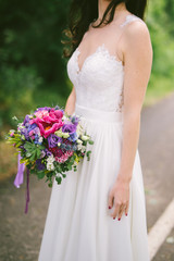 wedding bouquet with violet roses and long ribbon