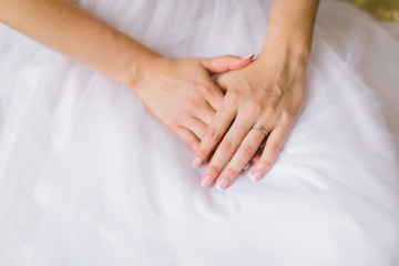 bride's hands with wedding ring