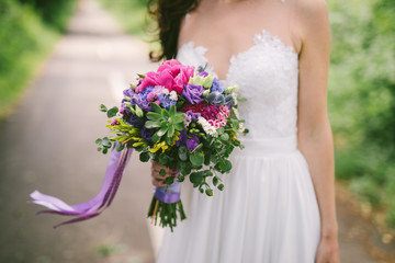 wedding bouquet with violet roses and long ribbon