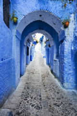 vertical view to tunnel on the blue street in old city in Morocco