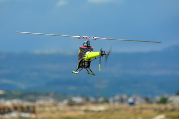 Fototapeta na wymiar Homemade radio control helicopter with electric motor on blue sky.