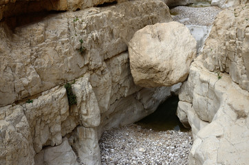 Naklejka premium Big sphere stone in wadi Murabba'at canyon ,Judean desert, Israel, famous natural landmark