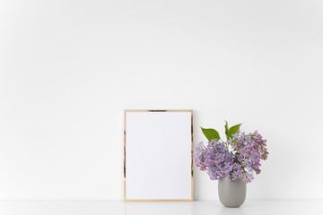 Gold frame with lilac bouquet on white background