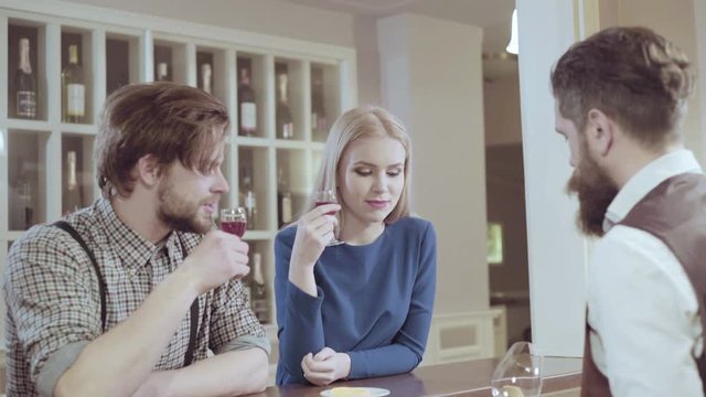 Beautiful couple in a restaurant. Cheerful couple in restaurant making an order. Romantic couple dating in pub