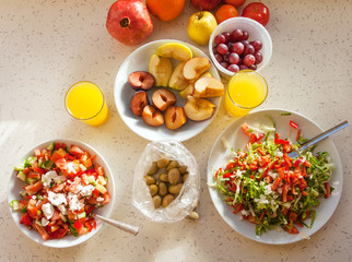 Healthy breakfast with salad, fruits and orange juice