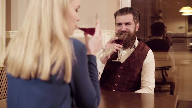 Couple in love. Handsome man flirting with cute woman in restaurant. Bearded man flirting with young sexy blonde