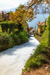 Fiumilatte sergio river flowing through the village of Varenna, Italy