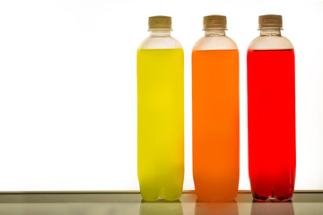 Bottles in a row with colorful content