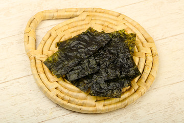 Nori sheets over wooden background