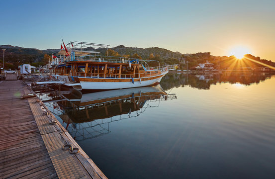 port of Kekova with moored yachts during sunset, Turkey