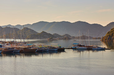 Fototapeta premium port of Kekova with moored yachts during sunset, Turkey