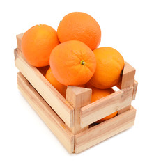 fresh oranges  in a wooden box on a white background