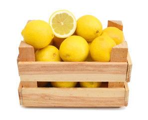 fresh lemons in a wooden box on a white background