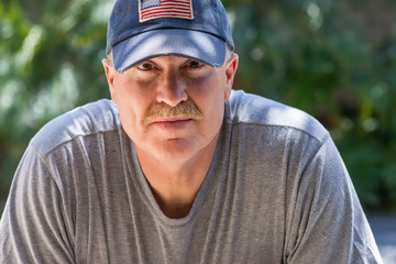 Senior male with serious look wearing USA