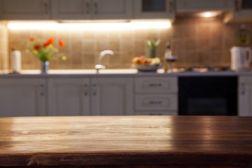 blurred kitchen interior with wooden desk space