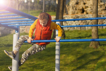 Obraz premium Kid with cool haircut doing fitness outdoor and having fun